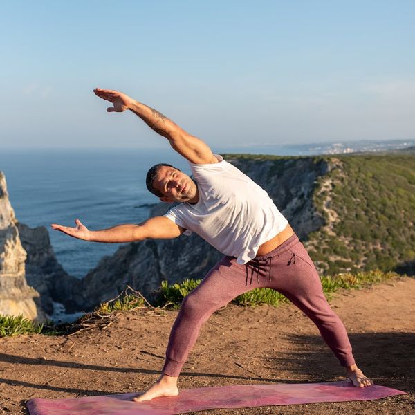 Man doing a powerful yoga warrior pose feeling energized.
